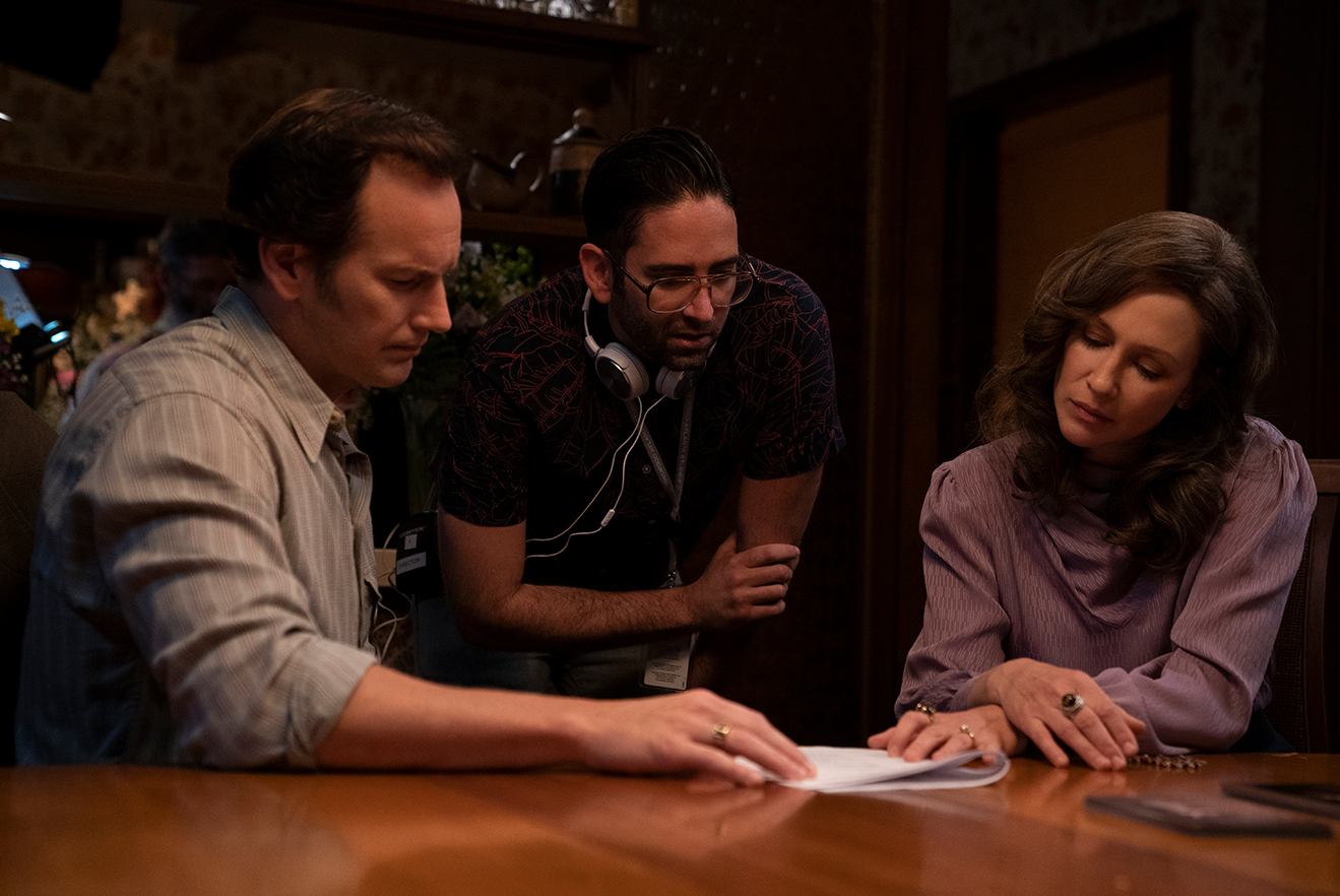 (L-r) PATRICK WILSON, director MICHAEL CHAVES and VERA FARMIGA on the set of New Line Cinema’s horror film “THE CONJURING: THE DEVIL MADE ME DO IT,” a Warner Bros. Pictures release.