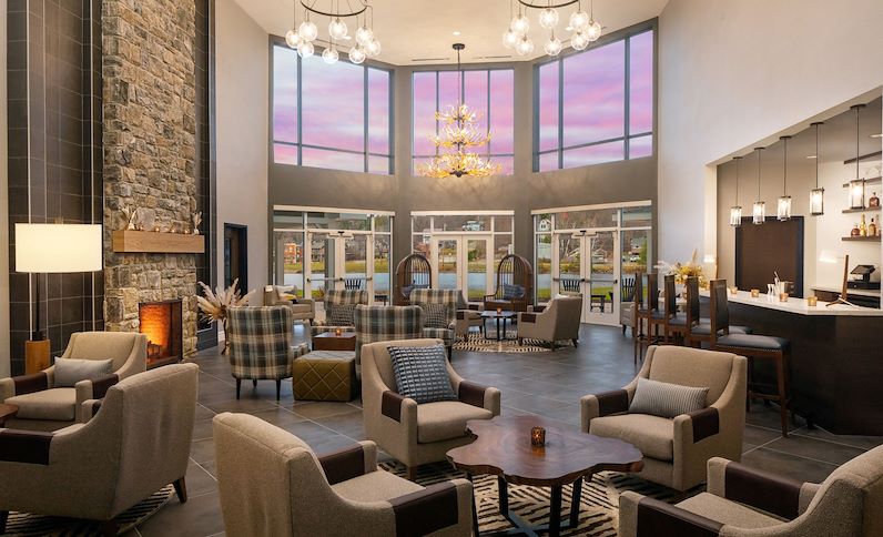 Navigator's Lounge, Lobby Bar with fireplace and lake front views at Saranac Waterfront Lodge