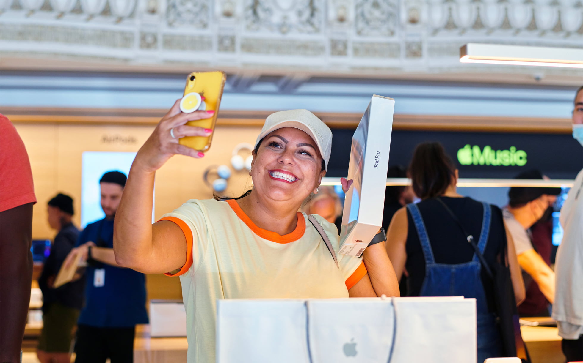 A customer celebrates her new iPad Pro with a selfie.