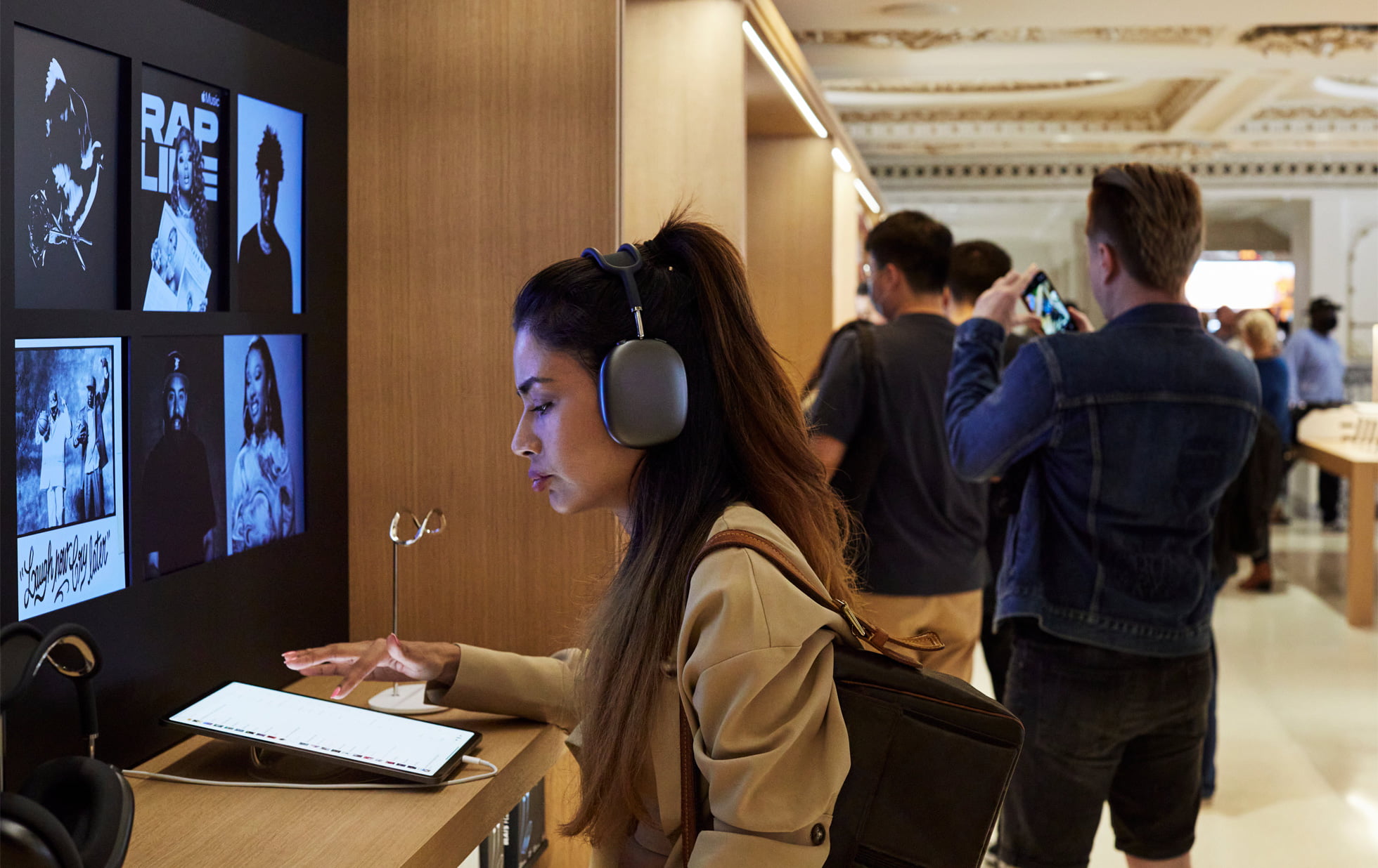 A customer test-drives the new iPad Pro with AirPods Max at Apple Tower Theatre.