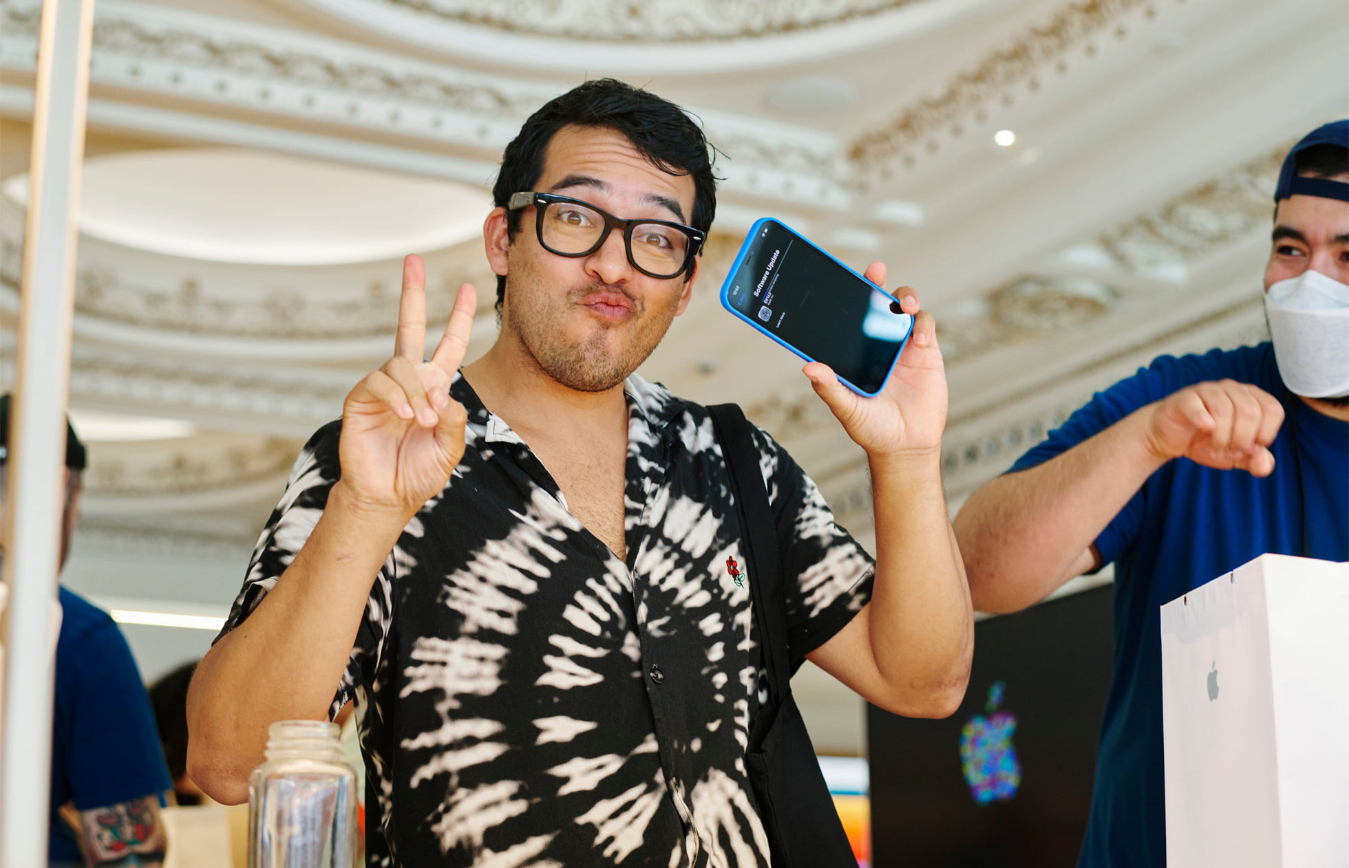 A customer explores the new iPhone 12 at Apple Tower Theatre.