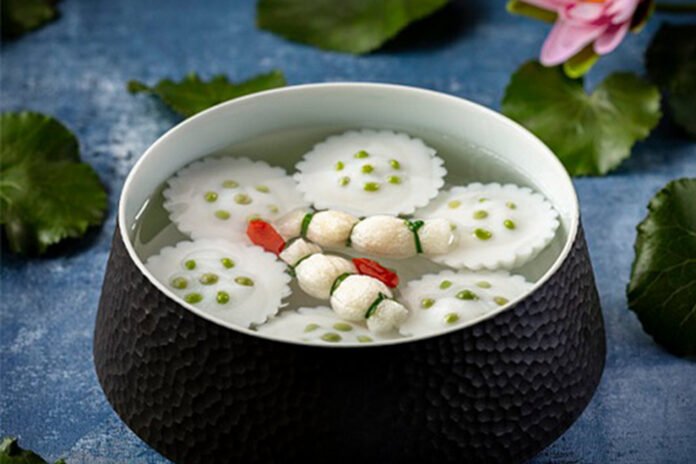 Lotus shaped fish dumplings in supreme consommé