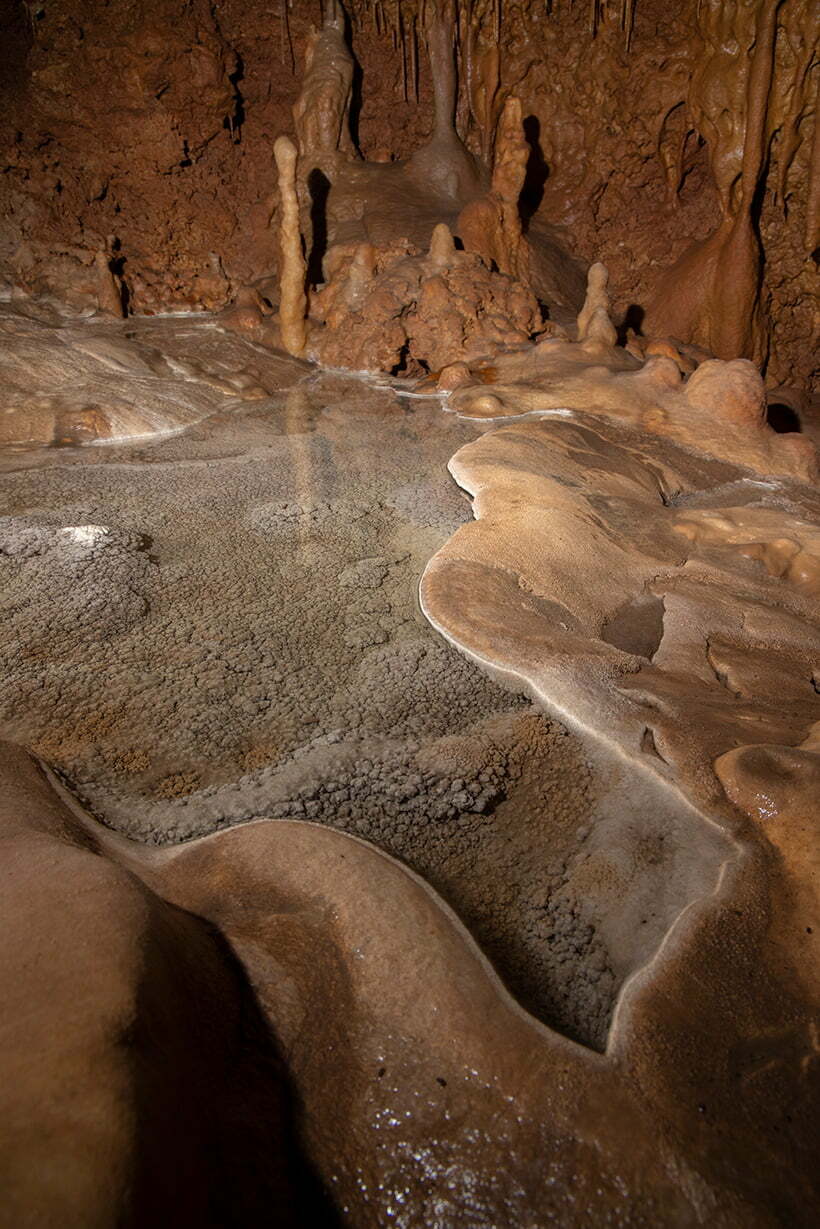 Water fills a rim pool at the end of the northern formation passage in Wild Cave.