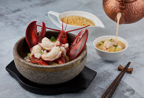 Poached Boston lobster in superior prawn broth served with crispy rice