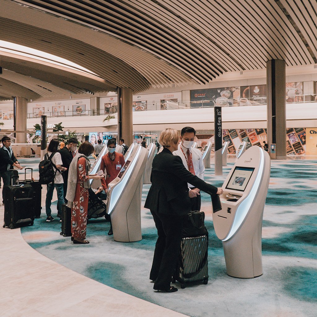 SIA passengers checking in for their flight at the automated check-in kiosks