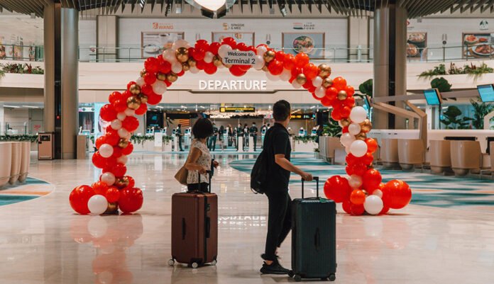 Balloon arches deck T2’s departure hall, welcoming passengers back to the newly reopened terminal.