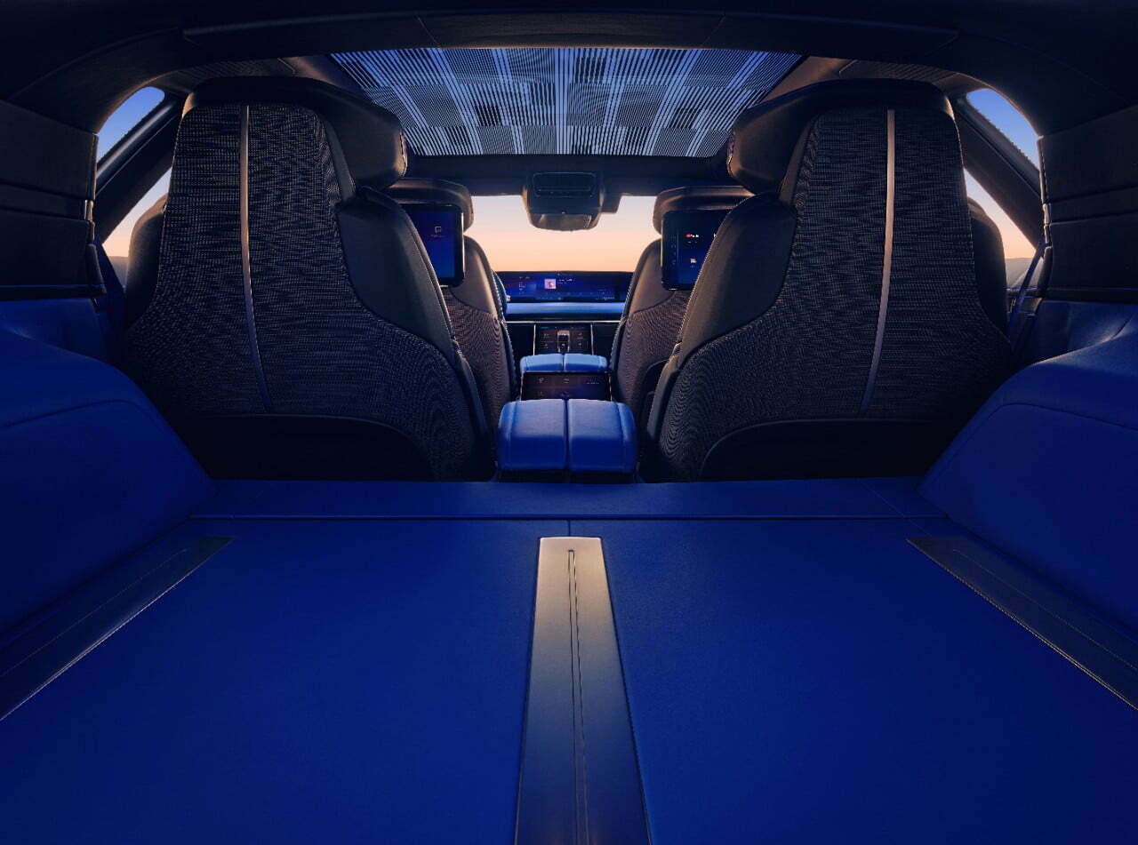 Interior view of the Cadillac CELESTIQ trunk looking forward to the front and rear seats and consoles.