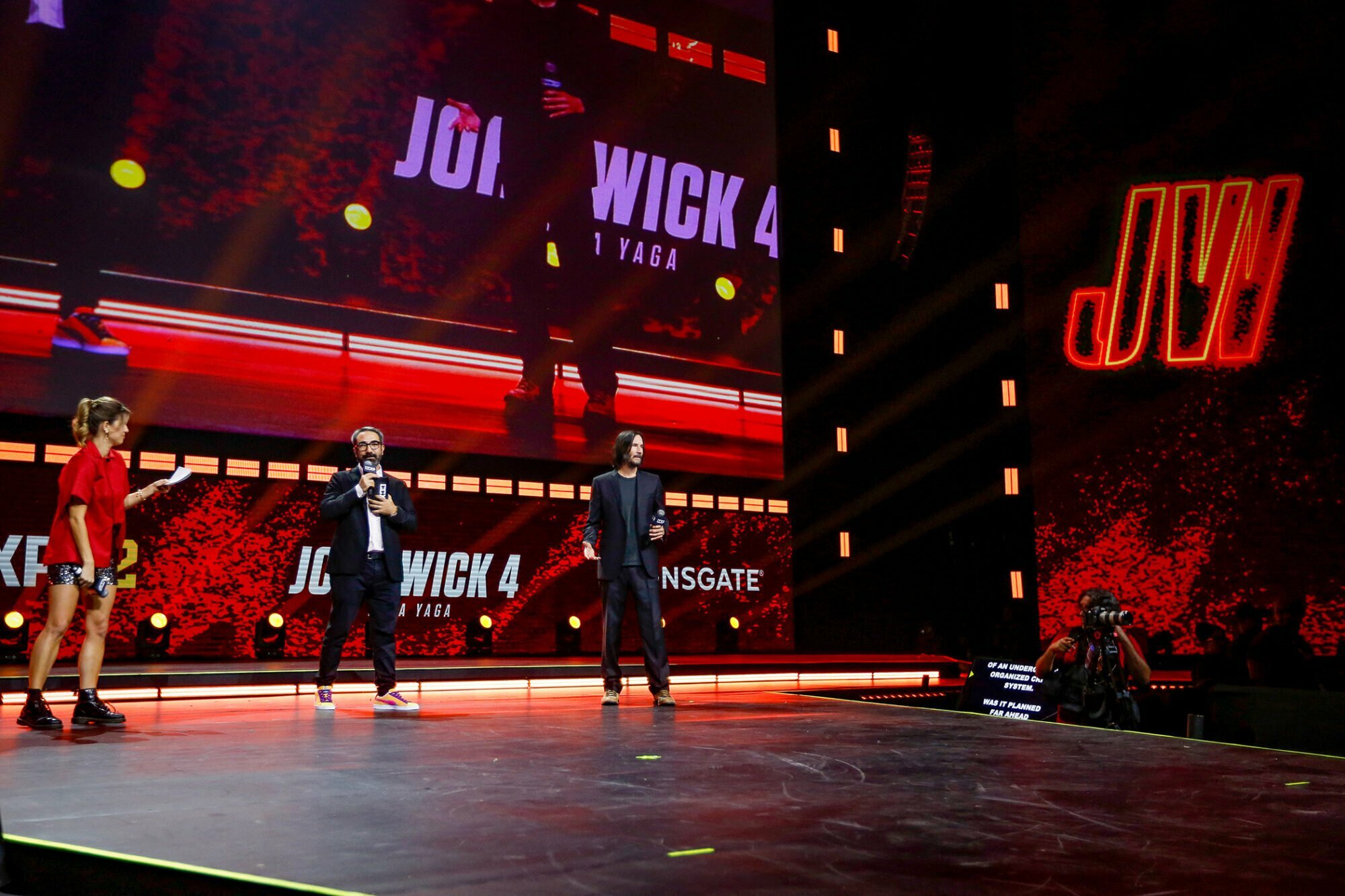 SAO PAULO, BRAZIL - DECEMBER 03: Keanu Reeves speaks during a panel of John Wick 4 at the Thunder Stage with the presenters Maria Bopp and Marcelo Forlani at Sao Paulo Expo on December 03, 2022 in Sao Paulo, Brazil. 