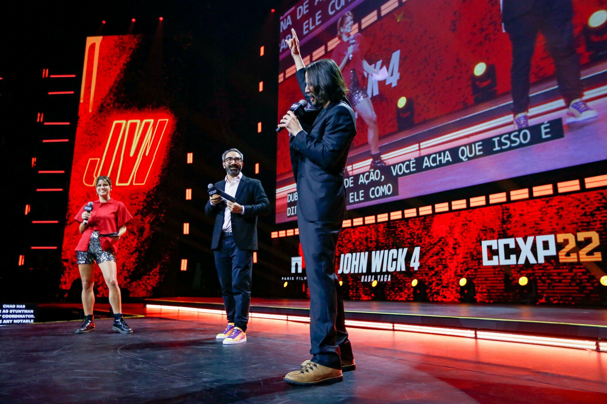 SAO PAULO, BRAZIL - DECEMBER 03: Keanu Reeves speaks during a panel of John Wick 4 at the Thunder Stage with the presenters Maria Bopp and Marcelo Forlani at Sao Paulo Expo on December 03, 2022 in Sao Paulo, Brazil.