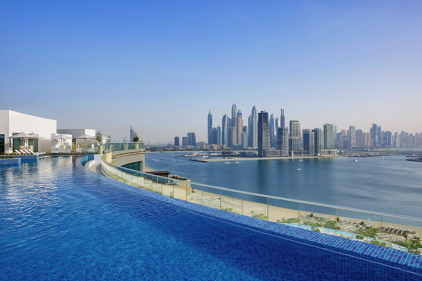 NH Collection Dubai The Palm - pool with beach and skyline view