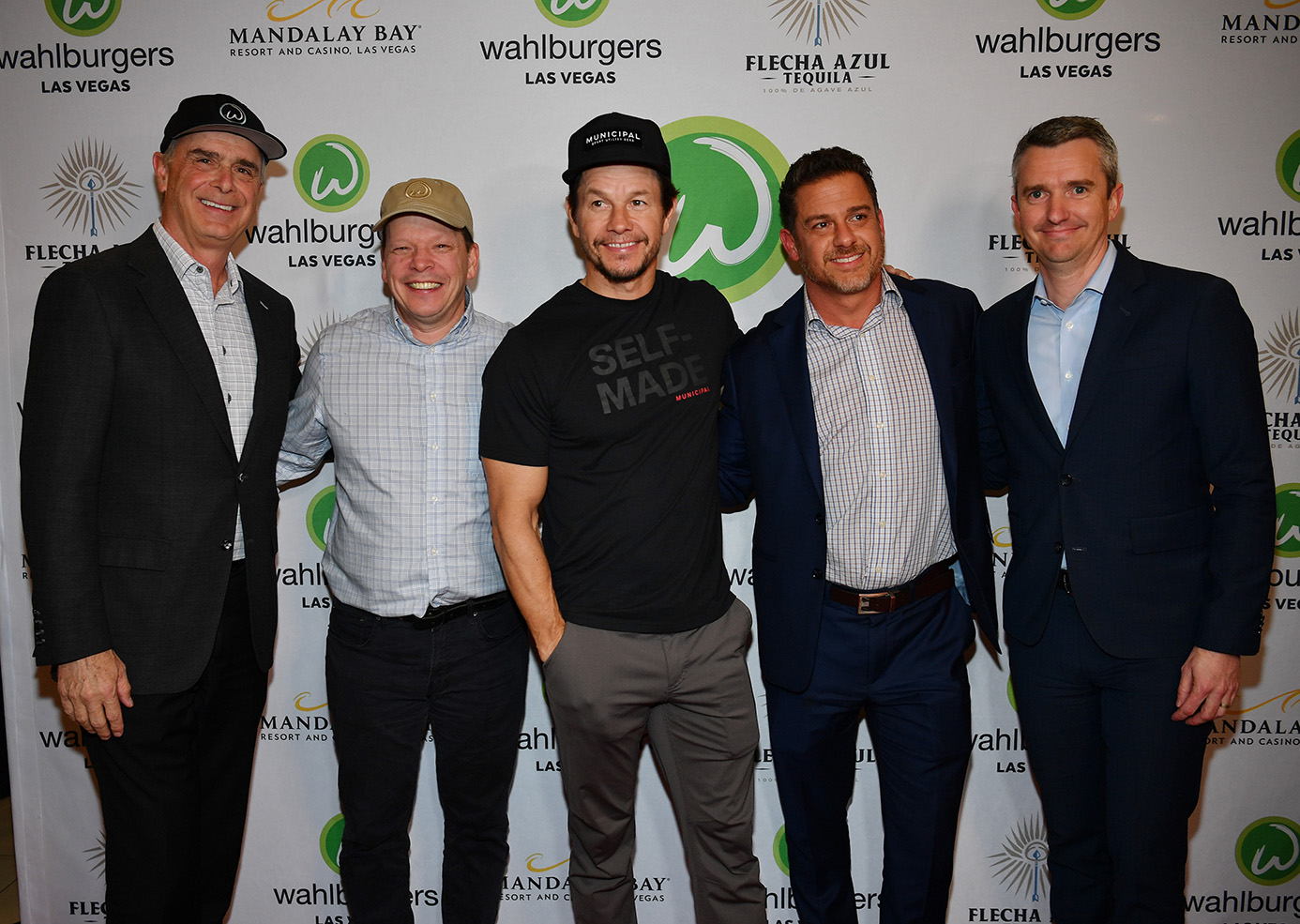 LAS VEGAS, NEVADA - MARCH 27: President and COO of Mandalay Bay, Delano and Luxor Chuck Bowling, Chef Paul Wahlberg, Mark Wahlberg, Vice President of Hospitality for Mandalay Bay, Delano and Luxor Andy Meese and Vice President of Food & Beverage Mandalay Bay, Delano and Luxor Emmanuel Cornet arrive at the grand opening of Whalburgers At Mandalay Bay Resort And Casino on March 27, 2023 in Las Vegas, Nevada.