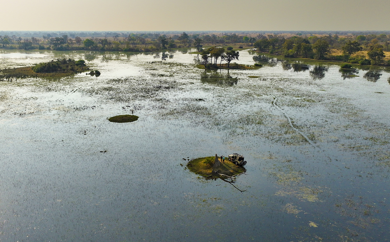 Aerial shot of the 4-wheel drive on a small 'island' surrounded by water.