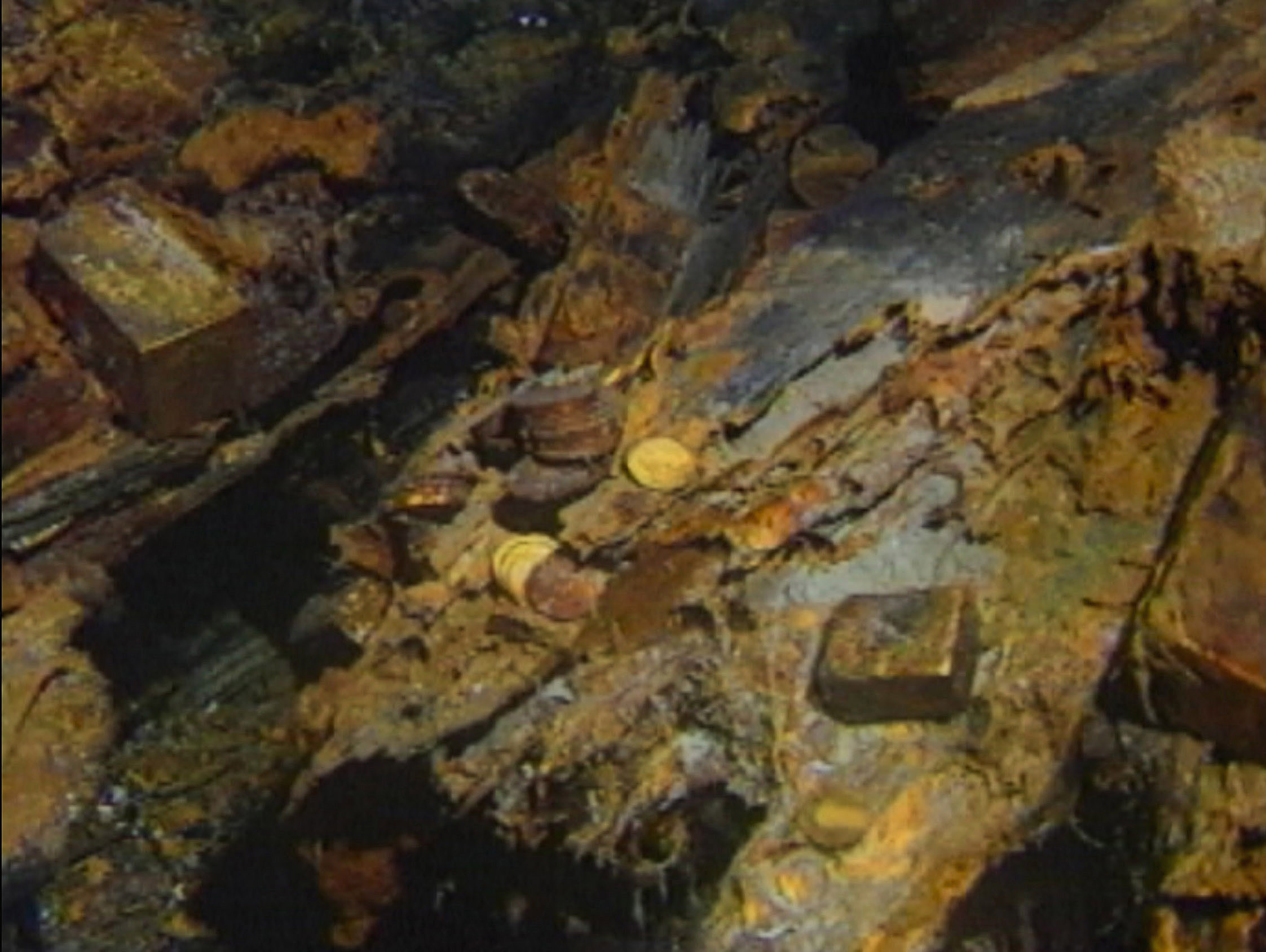 Gold bars and coins are pictured on the bottom of the seabed off the coast of North Carolina, USA. In 1989, maverick scientist Tommy Thompson stuns the world by recovering three tons of gold from a shipwreck deep in the Atlantic Ocean. What follows is a 30-year story of adventure, deception, and personal turmoil, taking him from venerated celebrity to infamous fugitive, and finally a defiant prisoner who refuses to give up his gold.