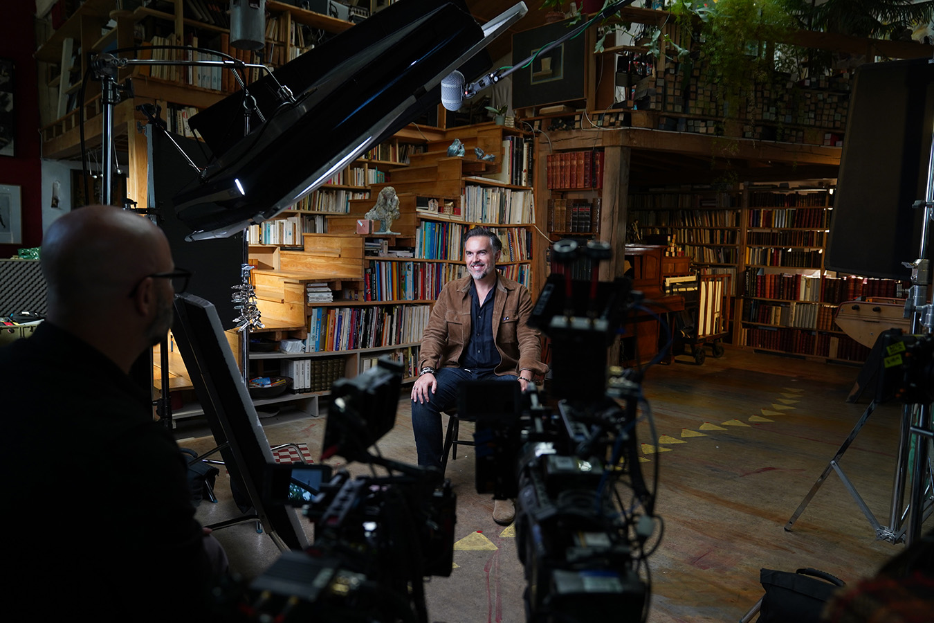 In this behind-the-scenes photo, French crime genre author Maxime Chattam gets ready to for an interview for "Killer Lies: Chasing a True Crime Con Man," a documentary series about obsession and deception, following the unraveling of Stephane Bourgoin's career as a best-selling author and serial killer expert.