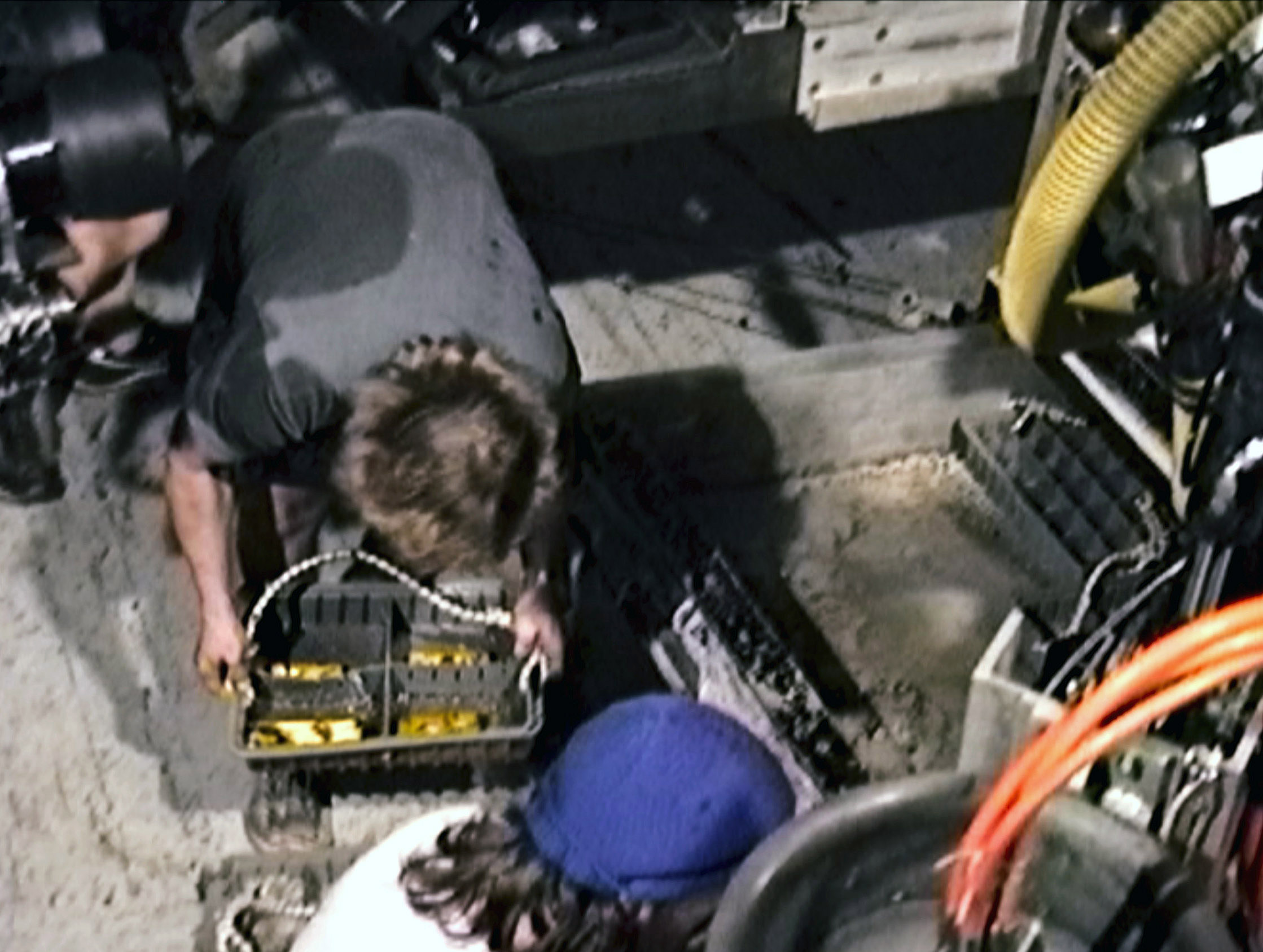 The crew looks at gold bars retrieved from the bottom of the seabed off the coast of North Carolina, USA. In 1989, maverick scientist Tommy Thompson stuns the world by recovering three tons of gold from a shipwreck deep in the Atlantic Ocean.