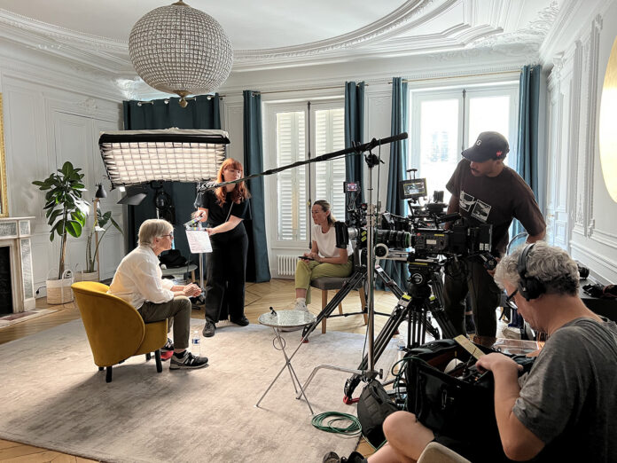 In this behind-the-scenes photo, Claude Marie is interviewed for 