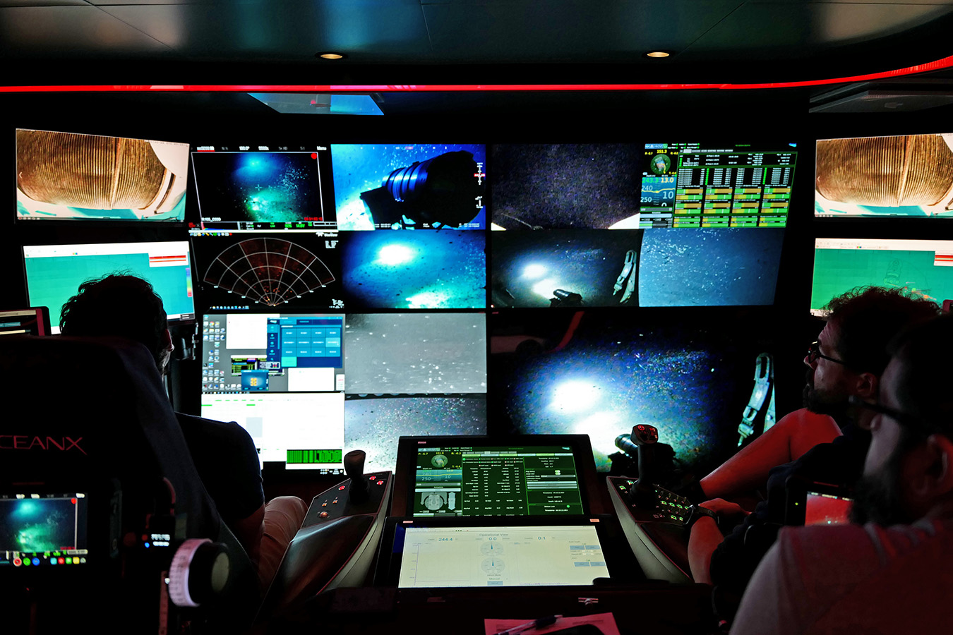 Eric Stackpole and Ewan Basin sit in ROV Mission Control.