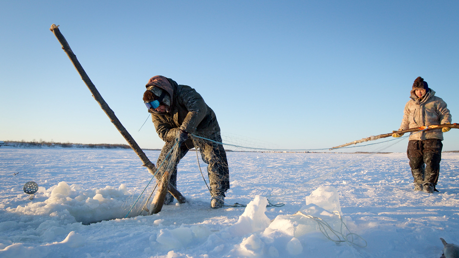 Gage and Avery Hoffman check their nets for fish.