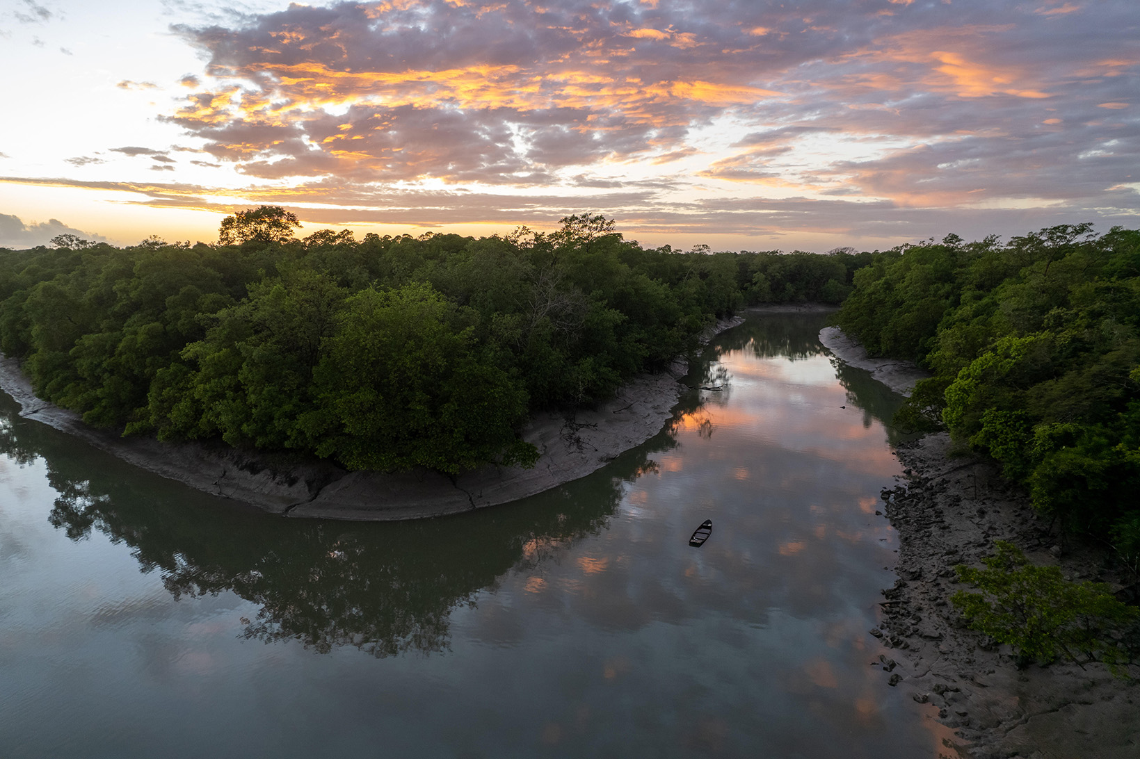 The sun rises near the mouth of the Amazon River.