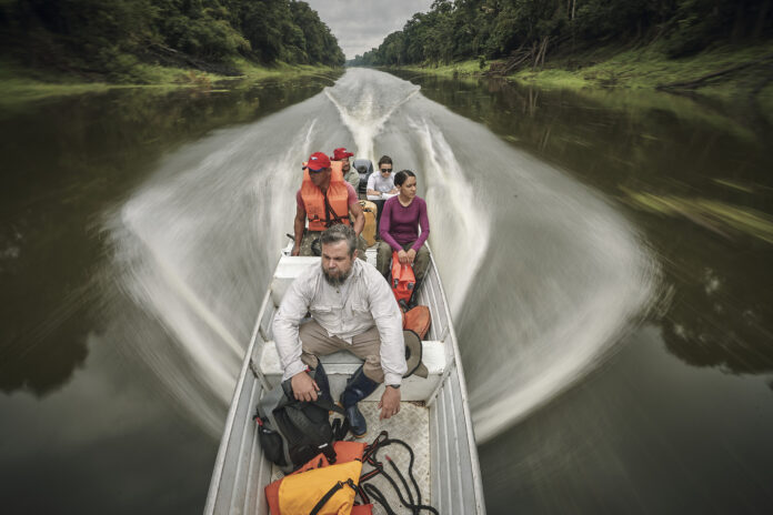 National Geographic Explorer Thiago Silva and his team travel by boat to a forest plot to scan it with LIDAR technology.