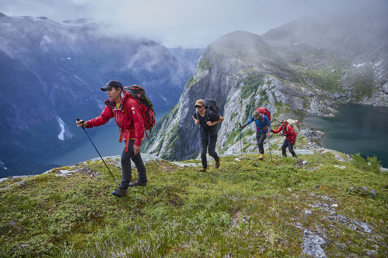 Alex Honnold, Taylor Shaffer, Tommy Caldwell and Waldo Etherington hiking up and over a mountain pass between Upper Scenery Lake and the Witches Cauldron.