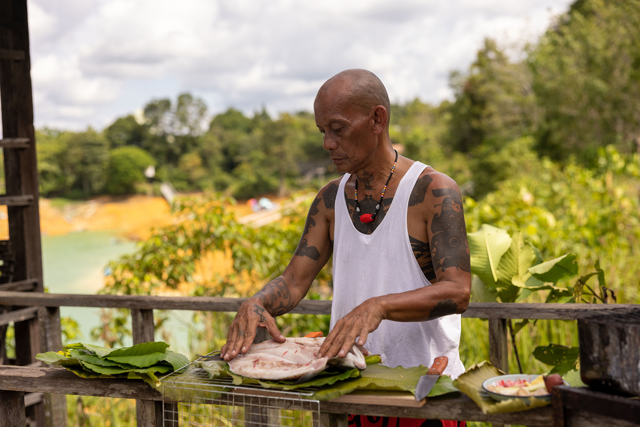 Peter prepares Ikan Semah for Henry Golding and Antoni Porowski.