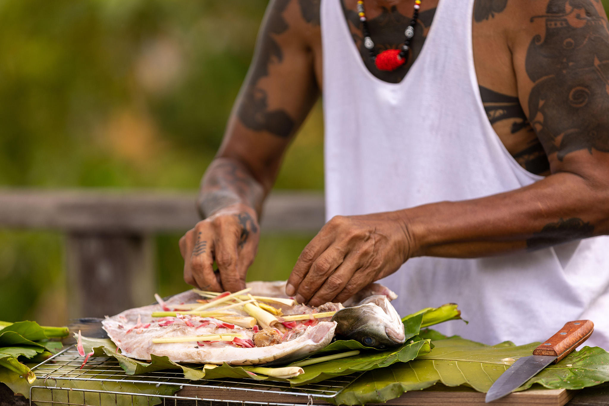 Peter prepares Ikan Semah for Henry Golding and Antoni Porowski.